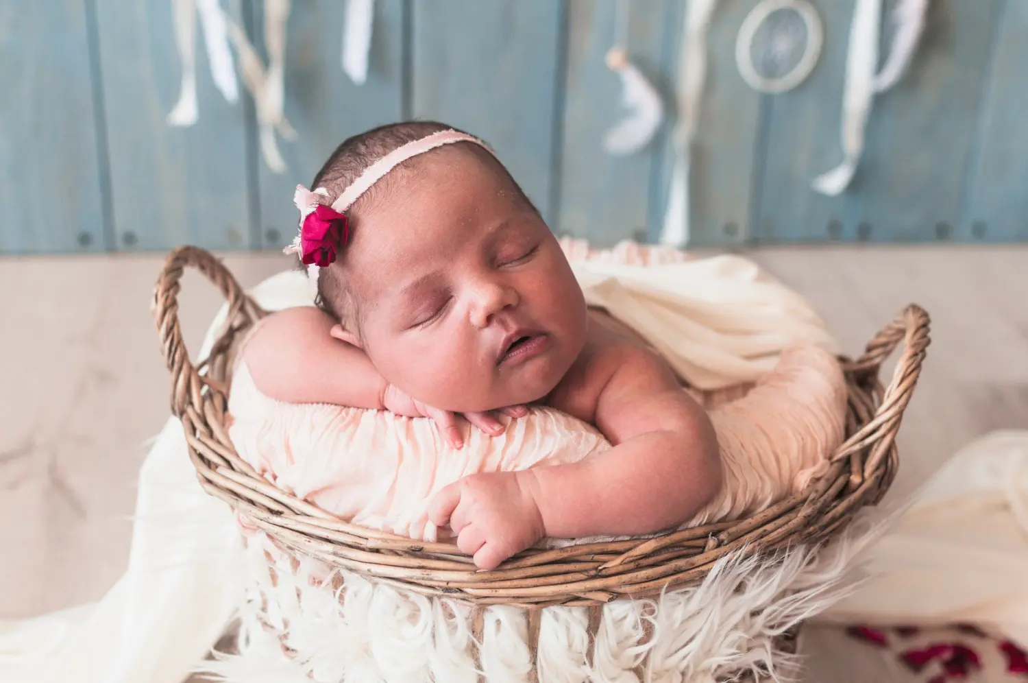 A healthy, sleeping newborn baby in a basket